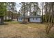 Traditional-style home with wood porch, gray siding, black shutters, and surrounded by trees at 602 N Mineral Springs Rd, Durham, NC 27703