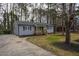 Charming single-story home featuring a wood porch, a long driveway and mature trees at 602 N Mineral Springs Rd, Durham, NC 27703