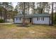 Traditional home with gray siding, black shutters, and wood front porch at 602 N Mineral Springs Rd, Durham, NC 27703