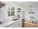 Bright kitchen featuring stainless steel appliances, white countertops, and a window view at 602 N Mineral Springs Rd, Durham, NC 27703