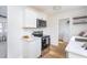 Well-lit kitchen area featuring white cabinetry and modern stainless steel appliances at 602 N Mineral Springs Rd, Durham, NC 27703
