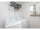 Well-organized laundry room with metal shelving and new washer and dryer units at 602 N Mineral Springs Rd, Durham, NC 27703