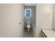 Bright bathroom featuring a toilet, tiled floors, and a window for natural light at 610 Shepard School Rd, Zebulon, NC 27597
