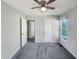 A cozy bedroom featuring carpet, a ceiling fan, and two closets with white doors at 610 Shepard School Rd, Zebulon, NC 27597