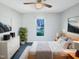 A staged bedroom with neutral paint and carpet, a ceiling fan and modern decor at 610 Shepard School Rd, Zebulon, NC 27597