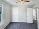 A cozy bedroom featuring carpet, a ceiling fan, and two closets with white doors at 610 Shepard School Rd, Zebulon, NC 27597