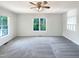 Bright and airy bedroom featuring neutral carpet and paint, a ceiling fan, and ample natural light at 610 Shepard School Rd, Zebulon, NC 27597