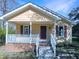 Charming one-story home with a quaint front porch and white railing offers great curb appeal at 610 Shepard School Rd, Zebulon, NC 27597