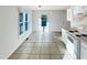 Bright, eat-in kitchen with tile floors, white appliances, ample storage, and natural light at 610 Shepard School Rd, Zebulon, NC 27597