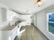 The cozy kitchen includes white cabinets, tile floor, a sink and an electric oven at 610 Shepard School Rd, Zebulon, NC 27597