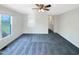 Open-concept living room with neutral gray carpet, ceiling fan and large window at 610 Shepard School Rd, Zebulon, NC 27597