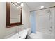 Cozy bathroom featuring a shower-tub combo, mirror, and sink at 63 Halter Ct, Angier, NC 27501