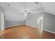 Spacious bedroom featuring laminate flooring, a ceiling fan, and a doorway to another room at 63 Halter Ct, Angier, NC 27501