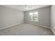 This bedroom offers neutral walls and carpet, window, and a ceiling fan at 63 Halter Ct, Angier, NC 27501