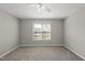 This bedroom offers neutral walls and carpet, window, and a ceiling fan at 63 Halter Ct, Angier, NC 27501