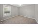 This bedroom offers neutral walls and carpet, window, and a ceiling fan at 63 Halter Ct, Angier, NC 27501