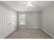 This bedroom offers neutral walls and carpet, window, and a closet at 63 Halter Ct, Angier, NC 27501