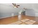 Large bonus room featuring laminate flooring, multiple ceiling fans, and built-in shelving at 63 Halter Ct, Angier, NC 27501