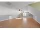 Large bonus room featuring laminate flooring, multiple ceiling fans, and built-in shelving at 63 Halter Ct, Angier, NC 27501