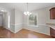 Cozy dining area with wood floors, bright window, and modern chandelier at 63 Halter Ct, Angier, NC 27501