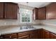 Galley kitchen featuring stainless steel sink with natural light at 63 Halter Ct, Angier, NC 27501