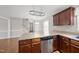 Bright kitchen featuring stainless steel dishwasher, wooden cabinets, and eat-in area at 63 Halter Ct, Angier, NC 27501