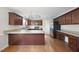 Open kitchen with wood cabinets, stainless appliances, and breakfast bar area at 63 Halter Ct, Angier, NC 27501