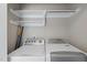 Convenient laundry room with shelving, washer and dryer at 63 Halter Ct, Angier, NC 27501
