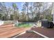 An above-ground pool is surrounded by a wood deck in the backyard at 63 Halter Ct, Angier, NC 27501