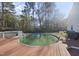 Backyard features an above-ground pool with wood deck and a grill at 63 Halter Ct, Angier, NC 27501