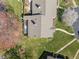 Overhead view of a quaint home and tree-filled lawn and patio at 6817 Fairpoint Ct, Raleigh, NC 27613