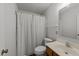 Cozy bathroom featuring a shower with striped curtain and single sink vanity at 6817 Fairpoint Ct, Raleigh, NC 27613