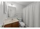 Cozy bathroom featuring a shower with striped curtain and single sink vanity at 6817 Fairpoint Ct, Raleigh, NC 27613