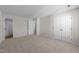 Spacious bedroom with neutral carpet, closet, and entrance to bathroom at 6817 Fairpoint Ct, Raleigh, NC 27613