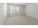 Well-lit bedroom features neutral carpeting and a large window at 6817 Fairpoint Ct, Raleigh, NC 27613