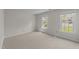 Bright bedroom featuring neutral carpeting and sun-drenched double windows at 6817 Fairpoint Ct, Raleigh, NC 27613