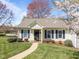 Charming home featuring blue shutters, a manicured lawn, and blooming trees creating curb appeal at 6817 Fairpoint Ct, Raleigh, NC 27613