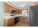 Functional kitchen features wood cabinets, stainless steel appliances, and light green walls at 6817 Fairpoint Ct, Raleigh, NC 27613