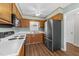 Practical kitchen offers wood cabinetry, stainless steel appliances, and a window view at 6817 Fairpoint Ct, Raleigh, NC 27613