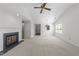 Bright living room with fireplace, neutral carpet, and vaulted ceiling provides a comfortable living space at 6817 Fairpoint Ct, Raleigh, NC 27613