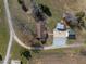 An aerial shot of a home with a detached garage, a barn, and a long driveway at 71 Romans Rd, Roxboro, NC 27574