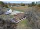 An aerial shot displaying a home with a large deck, a detached garage, and a basketball court at 71 Romans Rd, Roxboro, NC 27574