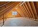 Spacious attic with plywood flooring, exposed framing, a window, and electrical outlets at 71 Romans Rd, Roxboro, NC 27574