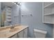 Bathroom featuring a vanity with ample counter space, storage shelves and white toilet at 71 Romans Rd, Roxboro, NC 27574