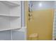 Shower area with white storage shelves and a yellow shower at 71 Romans Rd, Roxboro, NC 27574