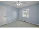 Cozy bedroom featuring a ceiling fan and a bright window with a view of the outdoors at 71 Romans Rd, Roxboro, NC 27574