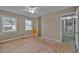 Bedroom featuring two windows, ceiling fan, and blank floor for customization at 71 Romans Rd, Roxboro, NC 27574