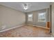 Bedroom featuring two windows, ceiling fan, and blank floor for customization at 71 Romans Rd, Roxboro, NC 27574