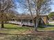 Inviting home with a spacious front porch and beautifully maintained landscaping, framed by mature trees at 71 Romans Rd, Roxboro, NC 27574