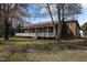 Charming home with a covered porch, green shutters and beautiful wooded surroundings at 71 Romans Rd, Roxboro, NC 27574